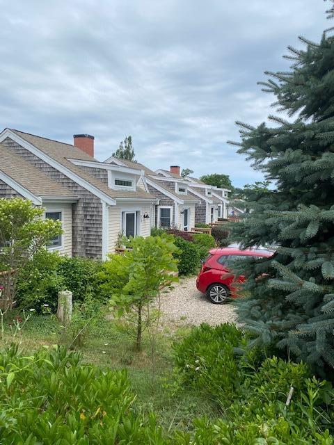 6 Shore Road, Unit 24 Truro, MA 02666 - Photo 46 of 46 a front view of a house with yard and outdoor seating