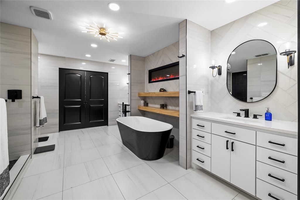 1300 Montclair Street Longview, TX 75601 - Photo 15 of 39 Bathroom featuring tile walls, a freestanding tub, vanity, recessed lighting, and light tile patterned floors