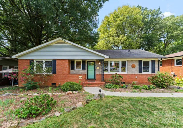 a front view of a house with a yard and porch