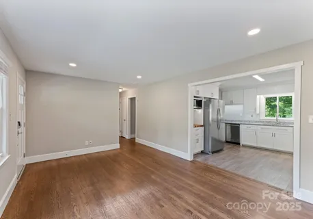 a view of a kitchen with a sink and a refrigerator