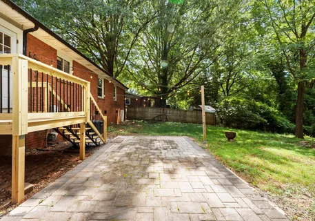 a view of a chair and tables in the backyard of the house