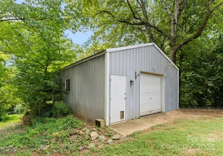 an outdoor view of house with backyard and trees