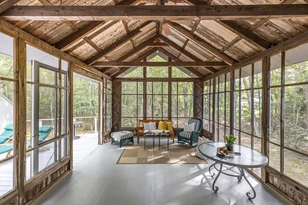 a living room with furniture and floor to ceiling windows