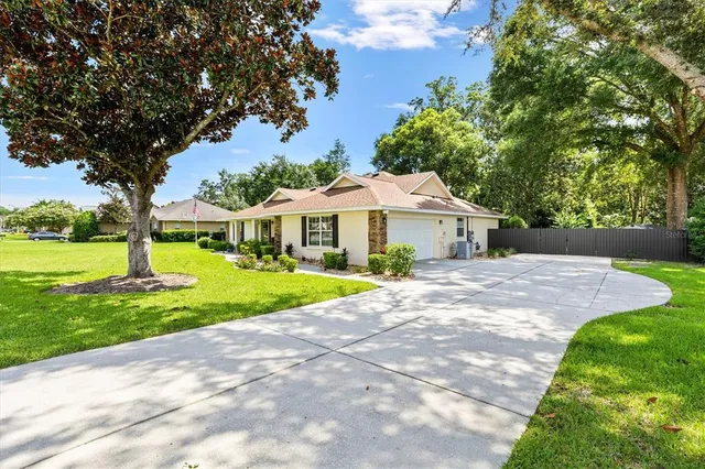 a front view of a house with yard and green space