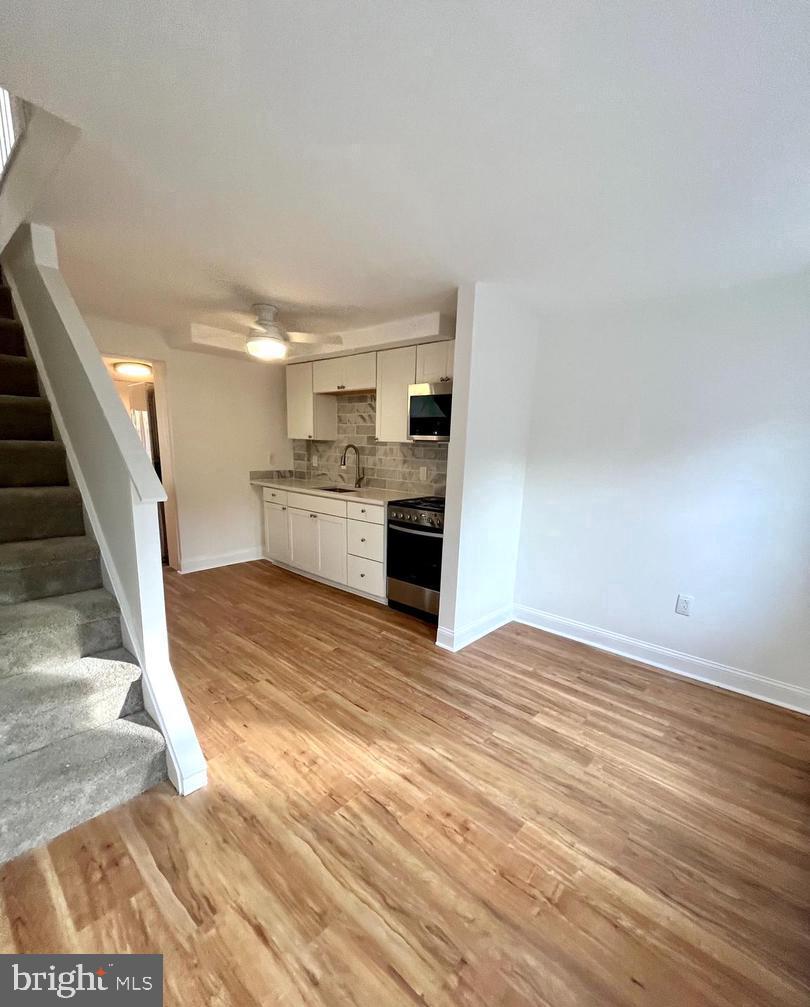 119 1/2 Maple Street, Unit 2 Conshohocken, PA 19428 - Photo 11 of 28 a view of a kitchen with a sink cabinets and a fireplace