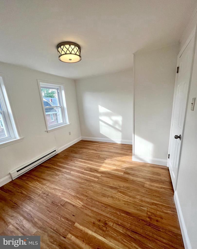 119 1/2 Maple Street, Unit 2 Conshohocken, PA 19428 - Photo 20 of 28 a view of empty room with window and wooden floor