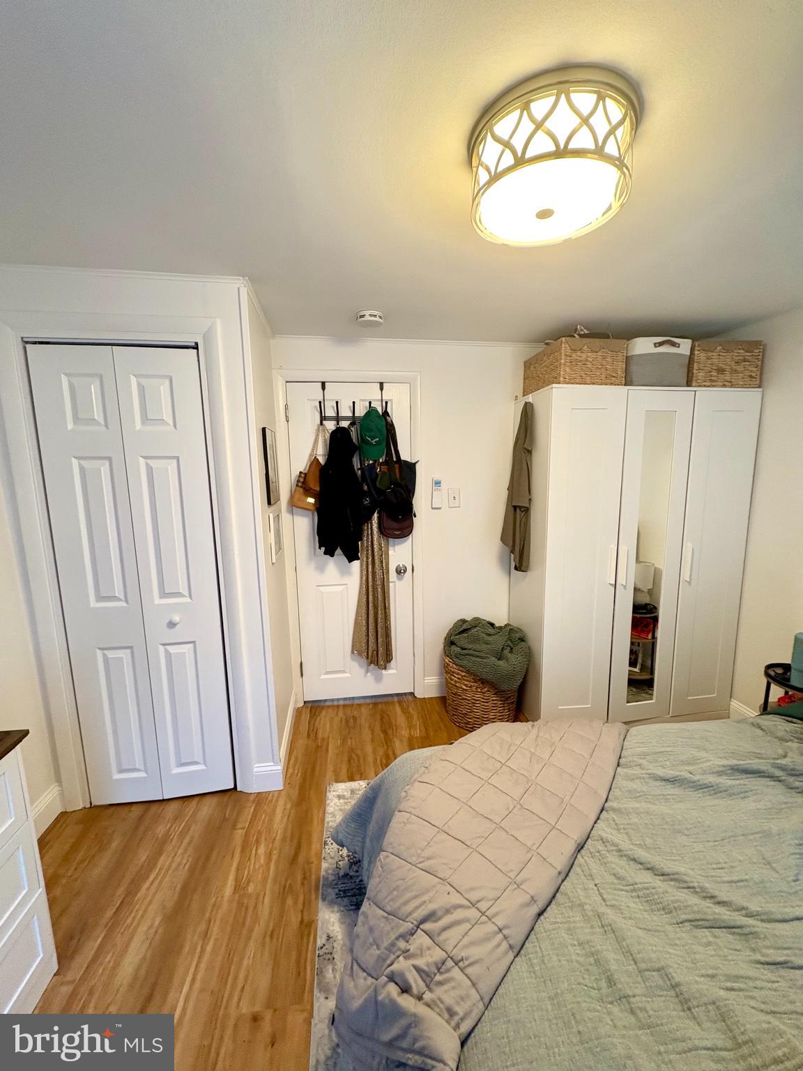 119 1/2 Maple Street, Unit 2 Conshohocken, PA 19428 - Photo 26 of 28 a bedroom with a bed and a chandelier