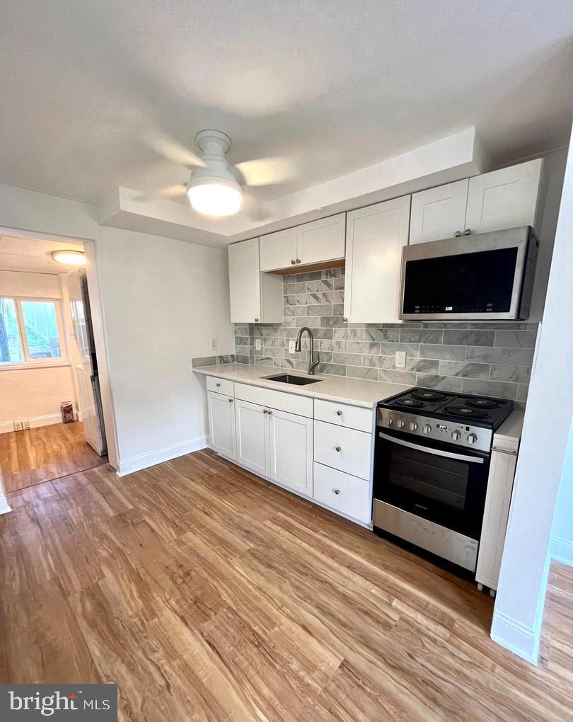 119 1/2 Maple Street, Unit 2 Conshohocken, PA 19428 - Photo 6 of 28 a kitchen with stainless steel appliances granite countertop a stove and a sink