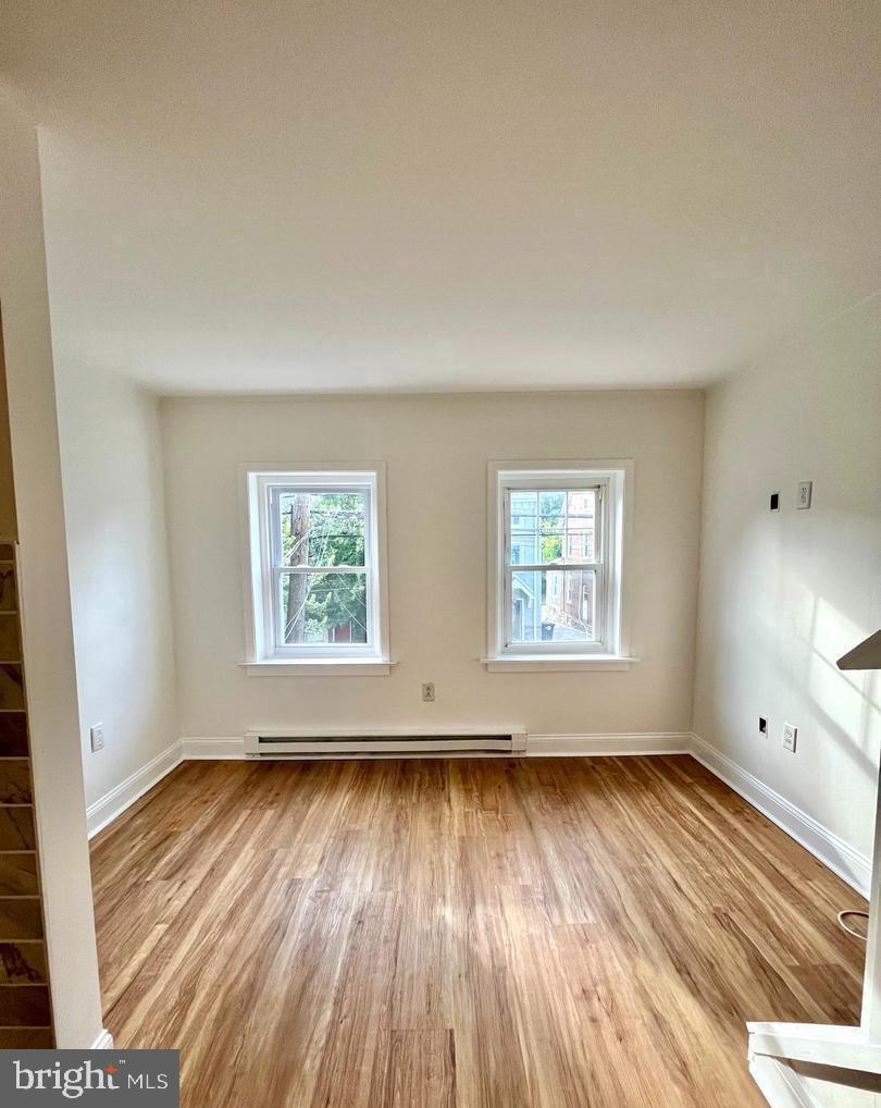 119 1/2 Maple Street, Unit 2 Conshohocken, PA 19428 - Photo 10 of 28 an empty room with wooden floor and windows