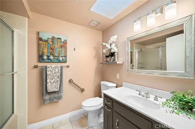 a bathroom with a sink a mirror a toilet and a shower