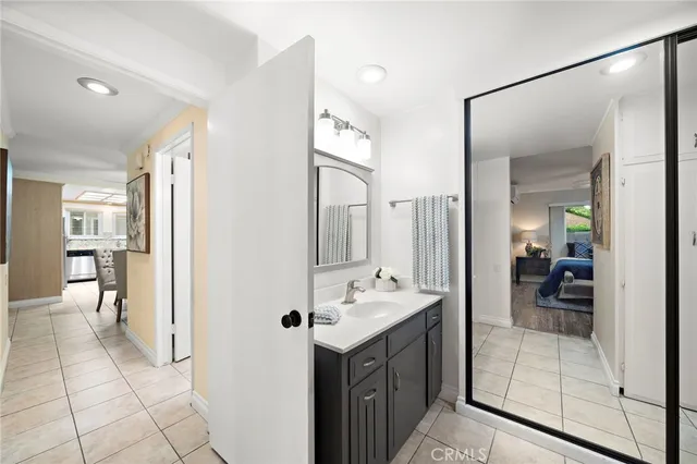 a view of hallway with furniture and a chandelier