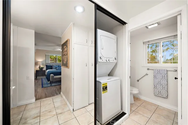 a view of a hallway with bathroom and glass door space