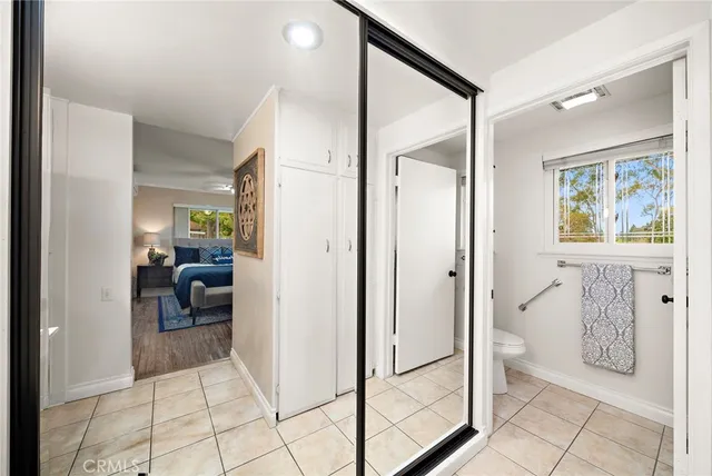 a en suite bathroom with a granite countertop sink a mirror and shower