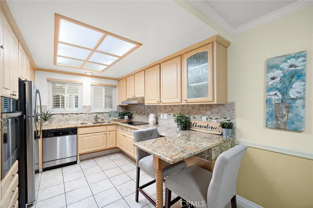 a kitchen with granite countertop a sink and appliances
