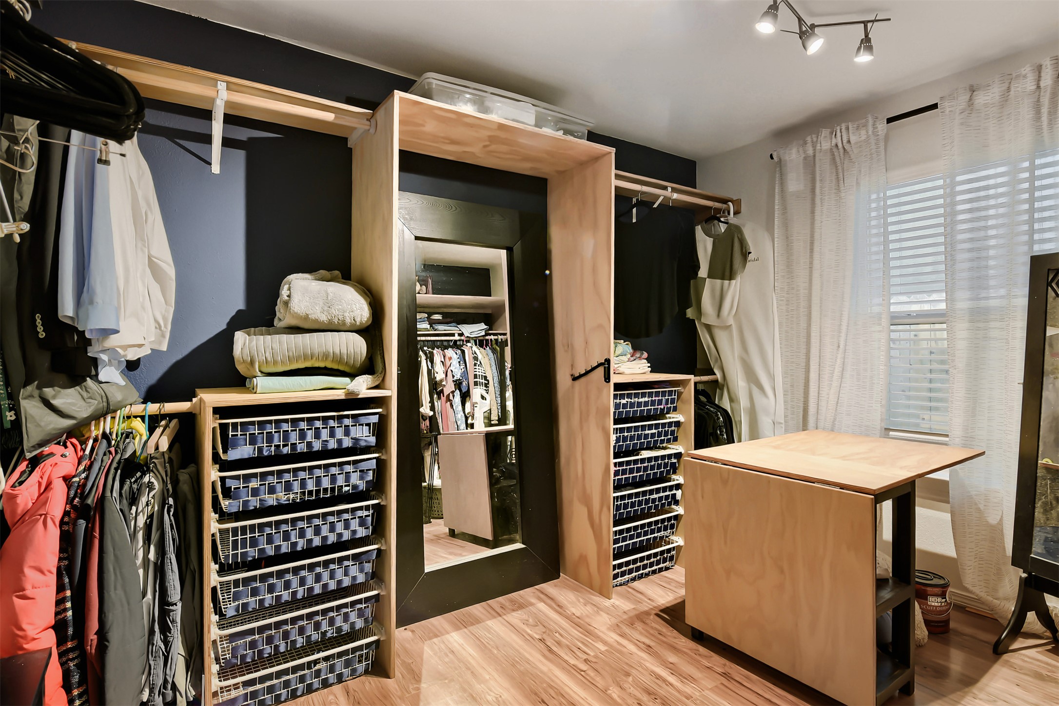 6105 Palm Circle Austin, TX 78741 - Photo 19 of 29 a view of walk in closet with clothes and shoes