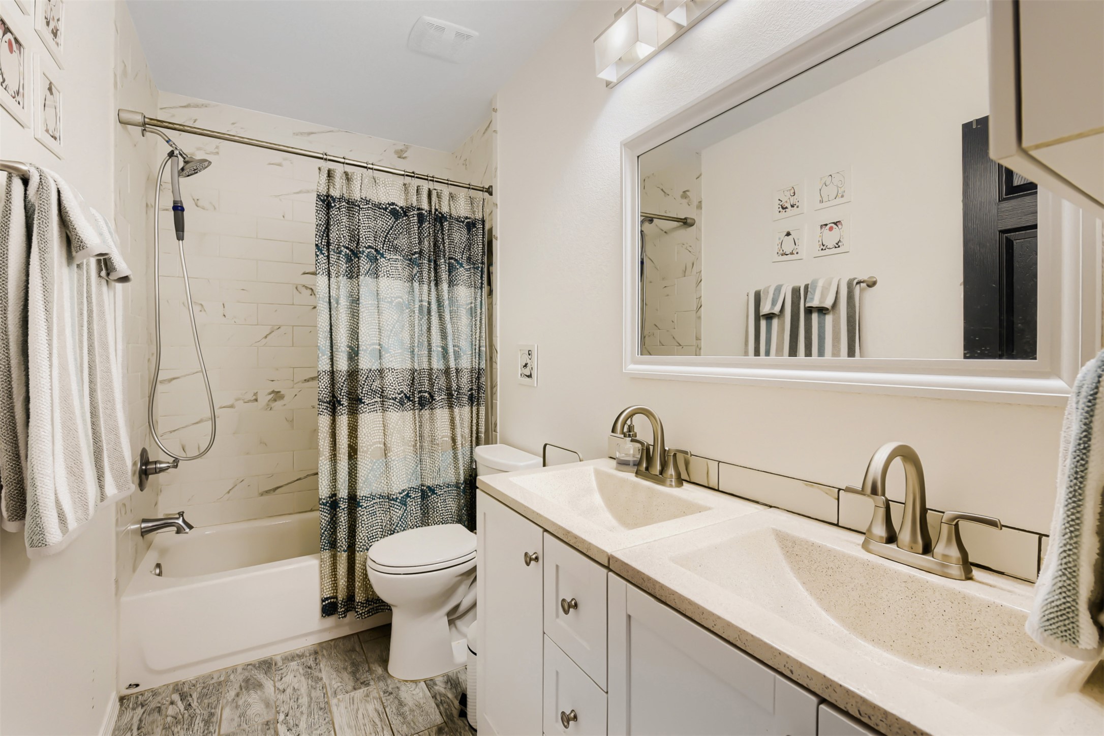 6105 Palm Circle Austin, TX 78741 - Photo 21 of 29 a bathroom with a sink a toilet and a large mirror