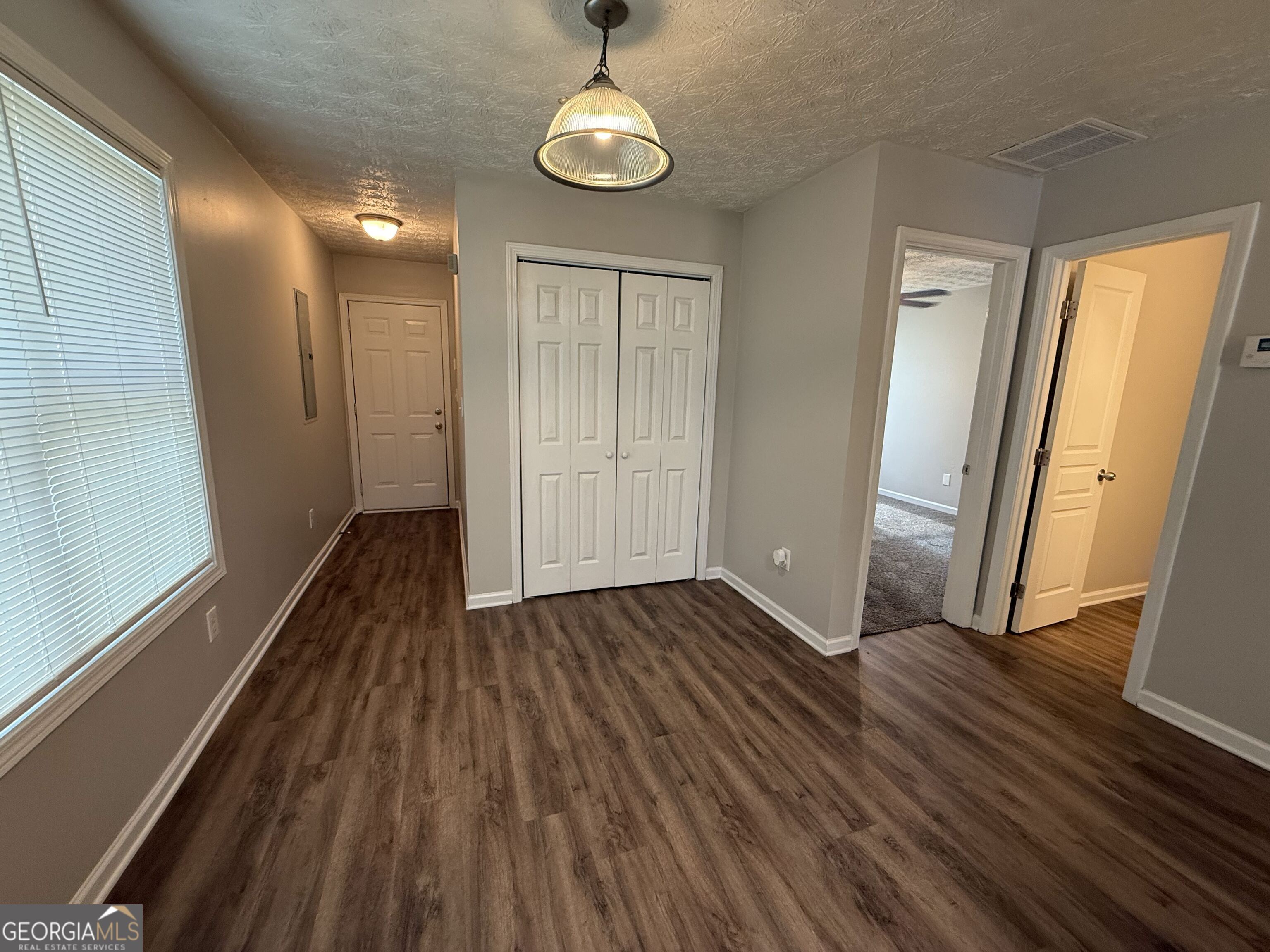 6132 Ruth Street Southwest Covington, GA 30014 - Photo 9 of 33 a view of a room with wooden floor and staircase
