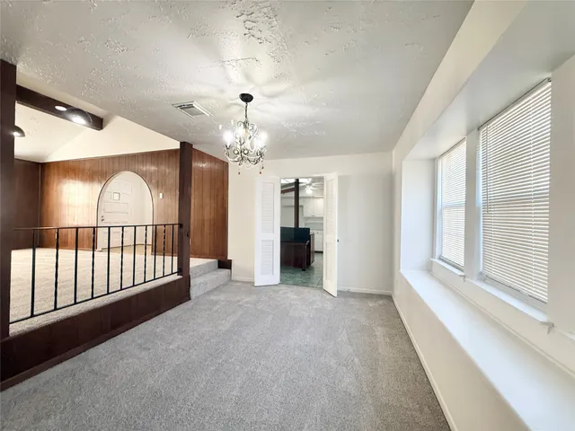a living room with a table and a large window