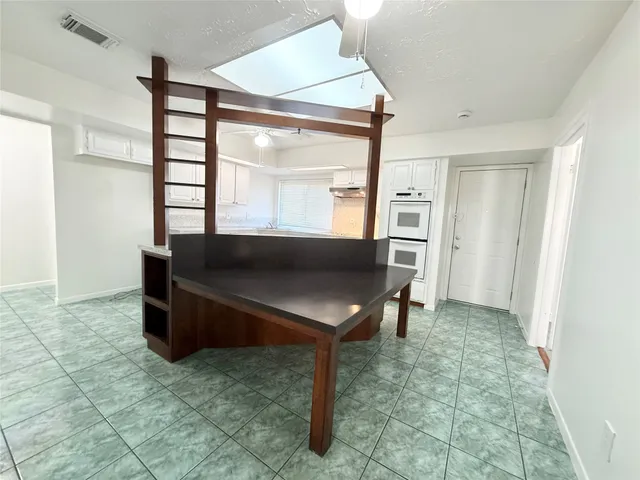 a kitchen with a sink a counter top space cabinets and stainless steel appliances