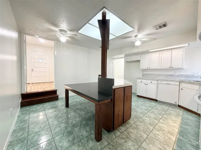 a view of a kitchen with a sink and a living room