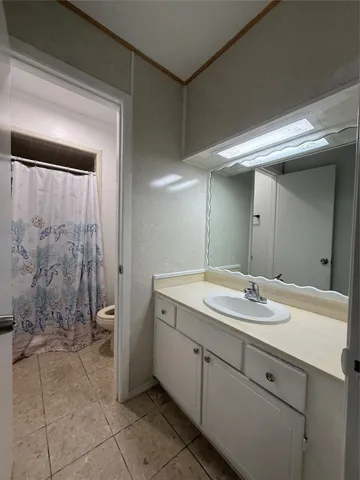 a white toilet sitting next to a shower curtain