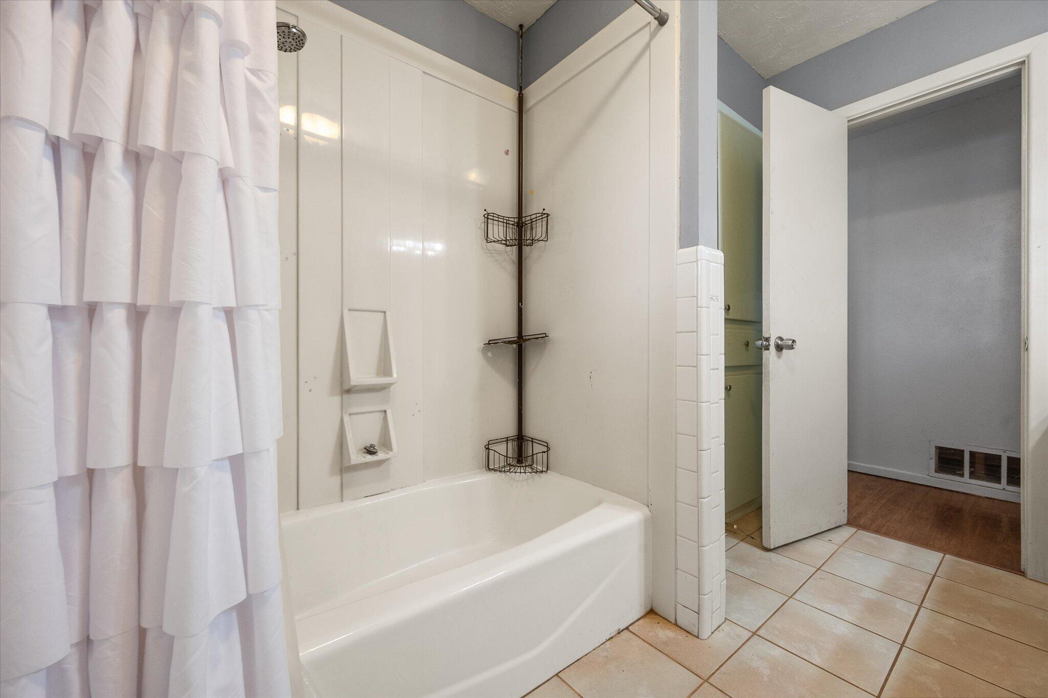 4604 27th Street Lubbock, TX 79410 - Photo 10 of 36 a bathroom with a bathtub and shower