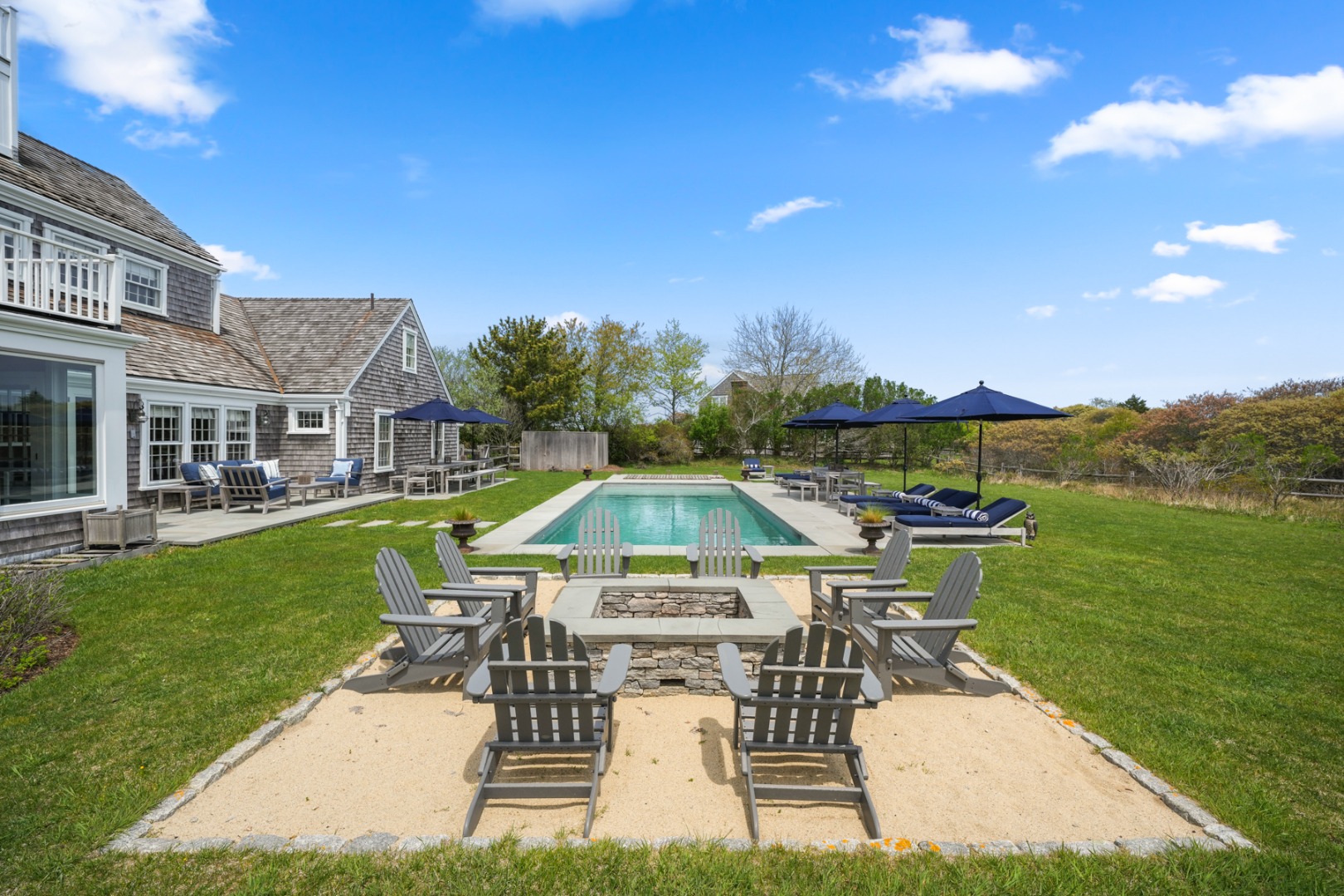 21 Quidnet Road Nantucket, MA 02554 - Photo 59 of 62 a view of a swimming pool and lounge chairs in back yard of the house