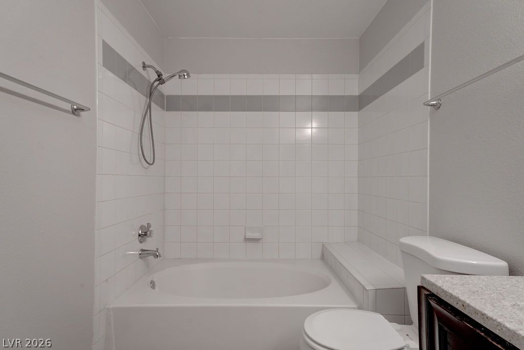 7885 West Flamingo Road, Unit 1016 Las Vegas, NV 89147 - Photo 20 of 24 A well-maintained bathroom with a spacious soaking tub and an integrated shower bench for comfort.