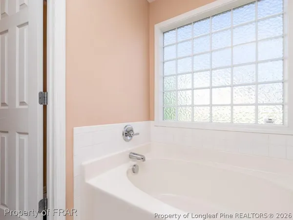 a white bath tub sitting next to a window