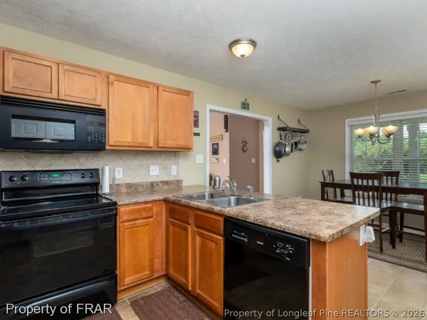a kitchen with a sink stove and microwave