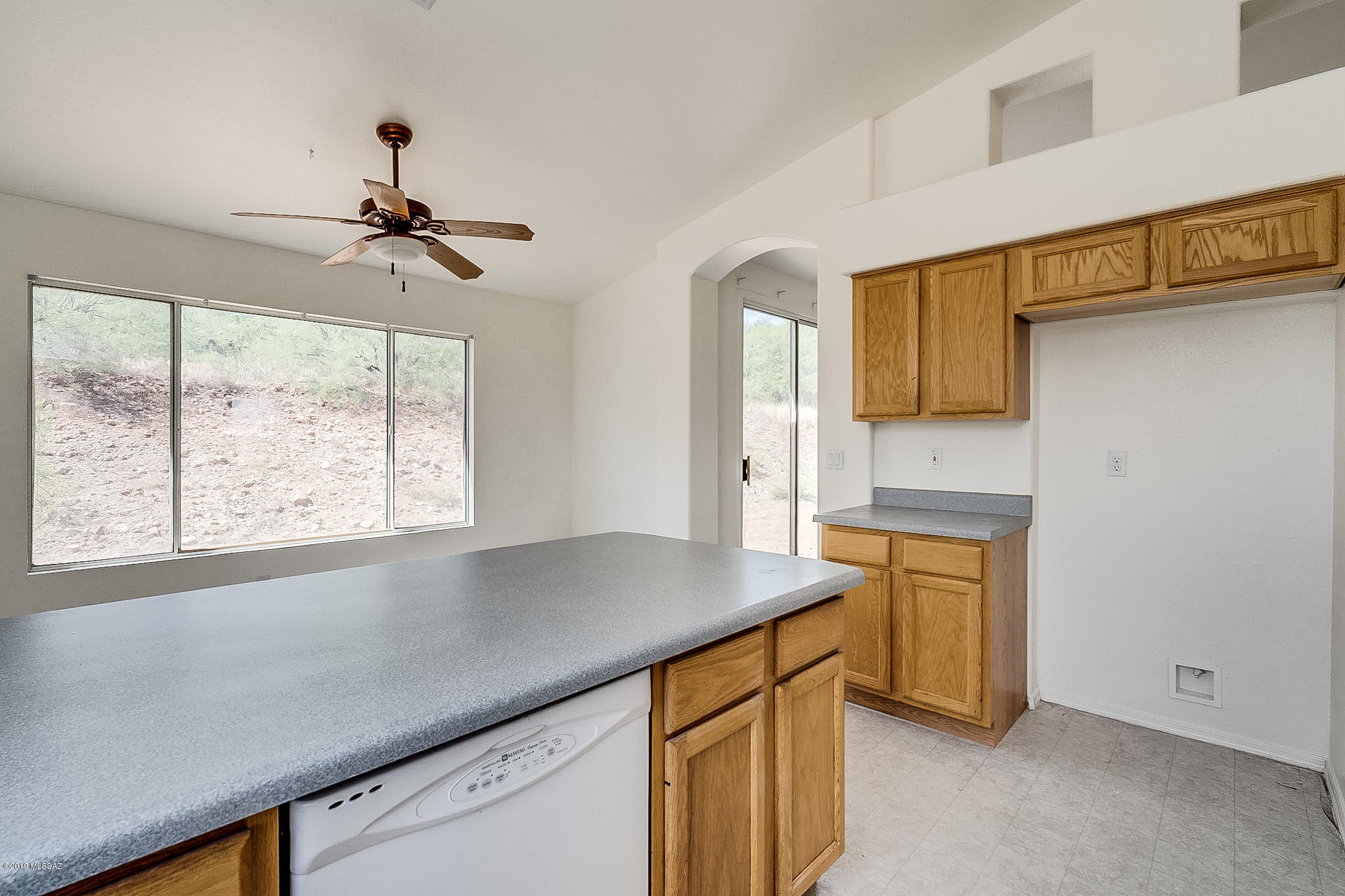 410 Wrightson Street Rio Rico, AZ 85648 - Photo 19 of 50 a kitchen with stainless steel appliances a sink stove and cabinets