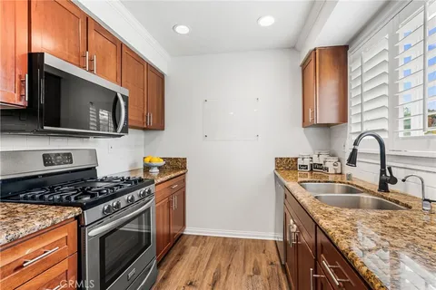 a kitchen that has a sink and a stove top oven