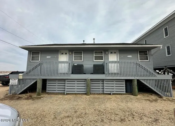 a view of house with deck and seating space