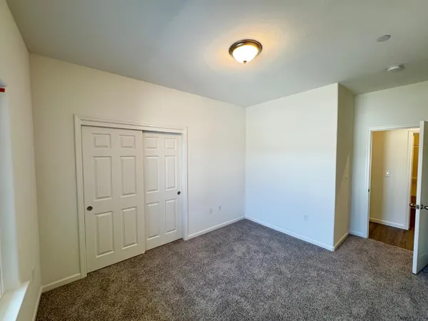 an empty room with closet area