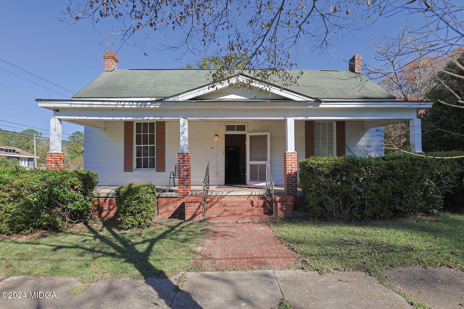 a front view of a house with garden
