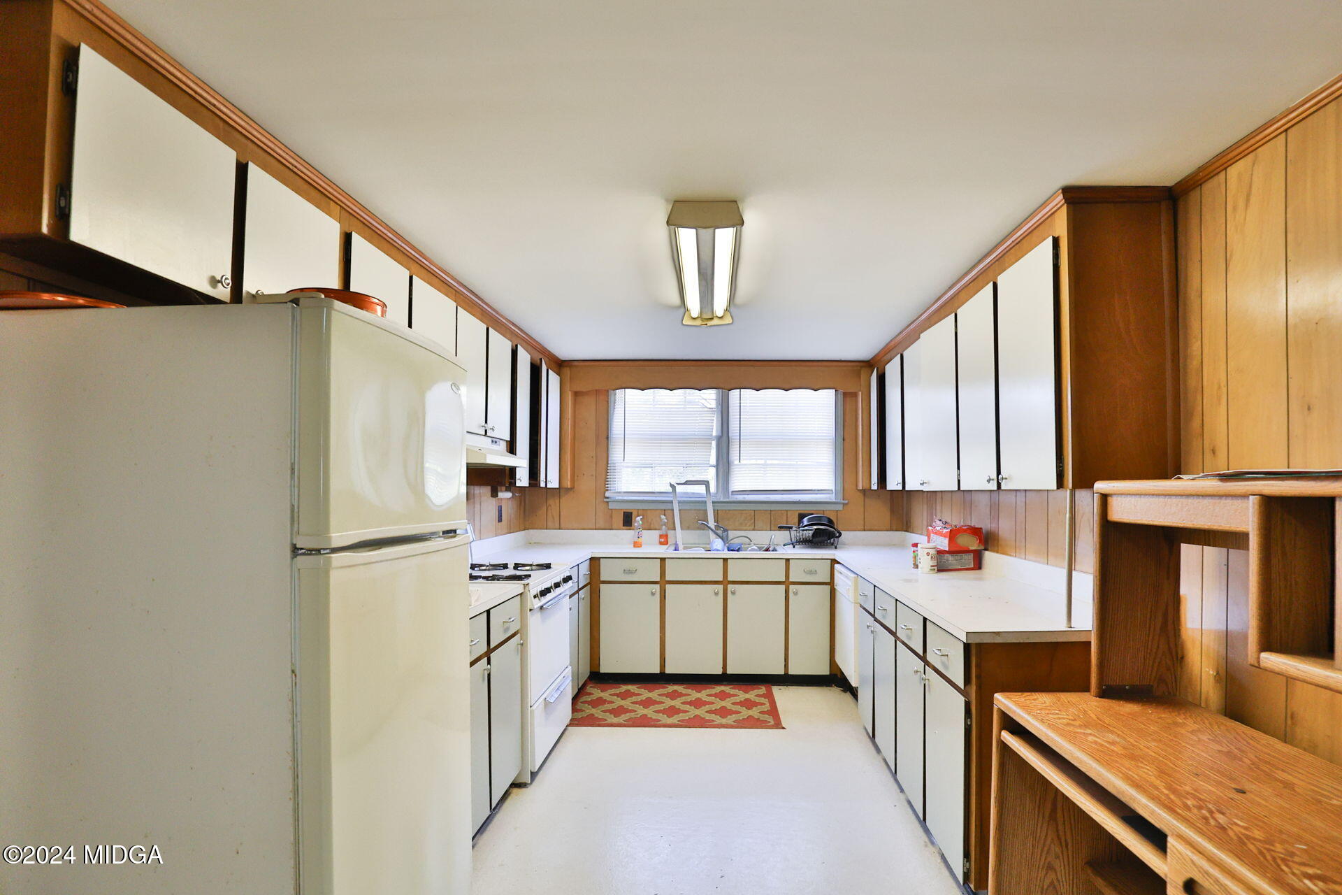 100 Minor Avenue Montezuma, GA 31063 - Photo 11 of 19 a kitchen with a sink a stove and cabinets