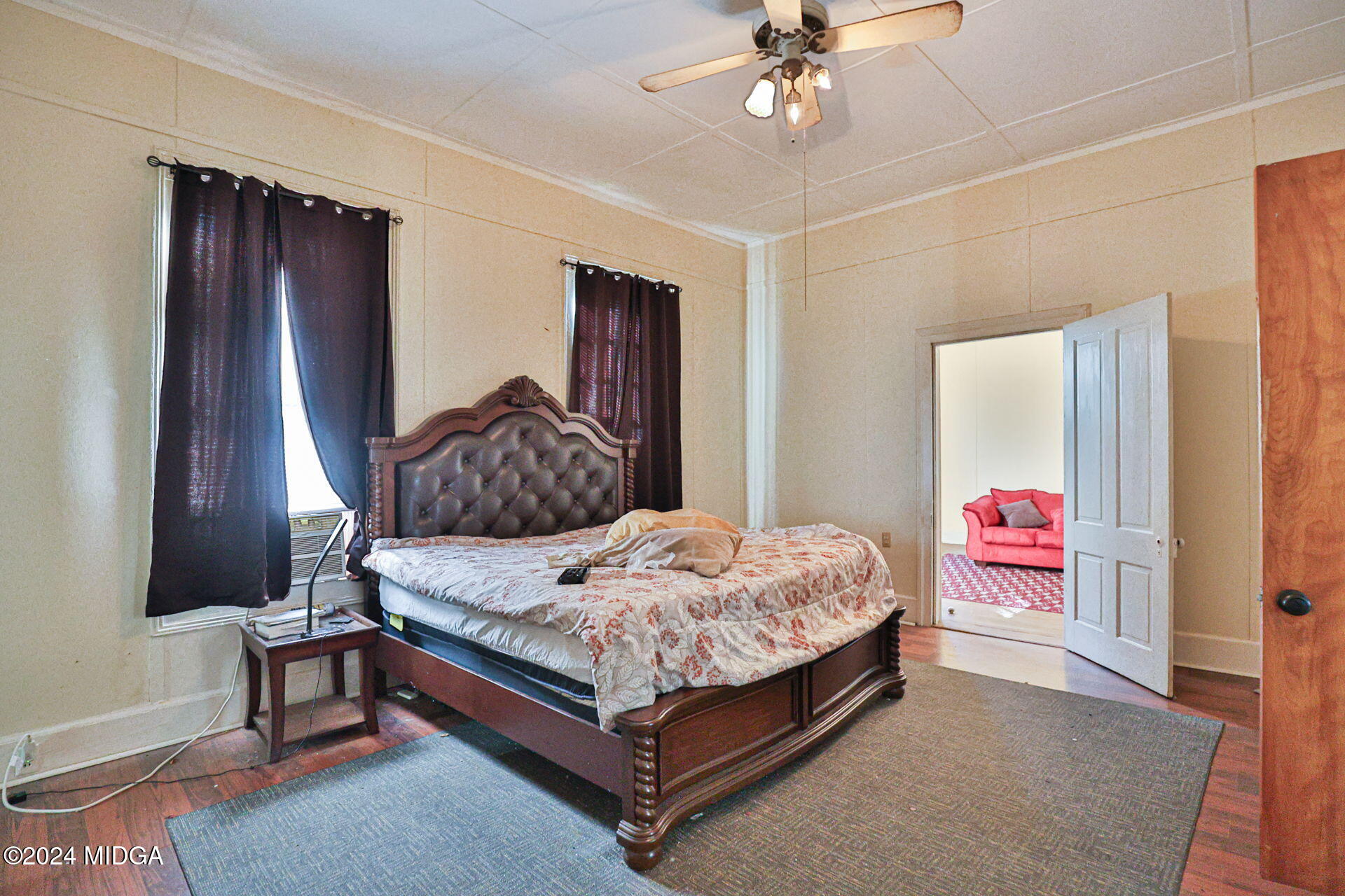100 Minor Avenue Montezuma, GA 31063 - Photo 12 of 19 a bedroom with a bed and a chandelier