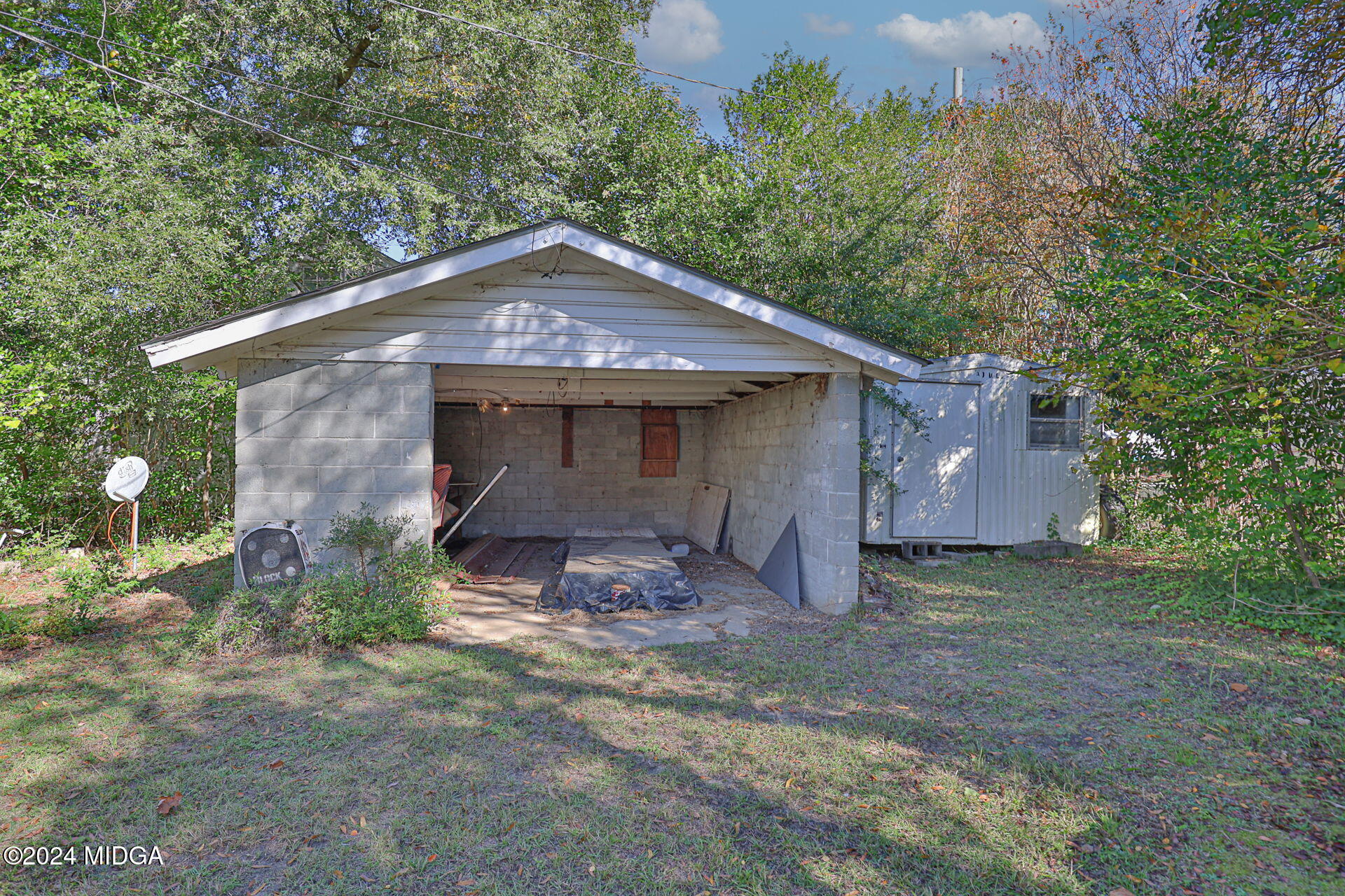 100 Minor Avenue Montezuma, GA 31063 - Photo 6 of 19 a front view of a house with a yard and garage