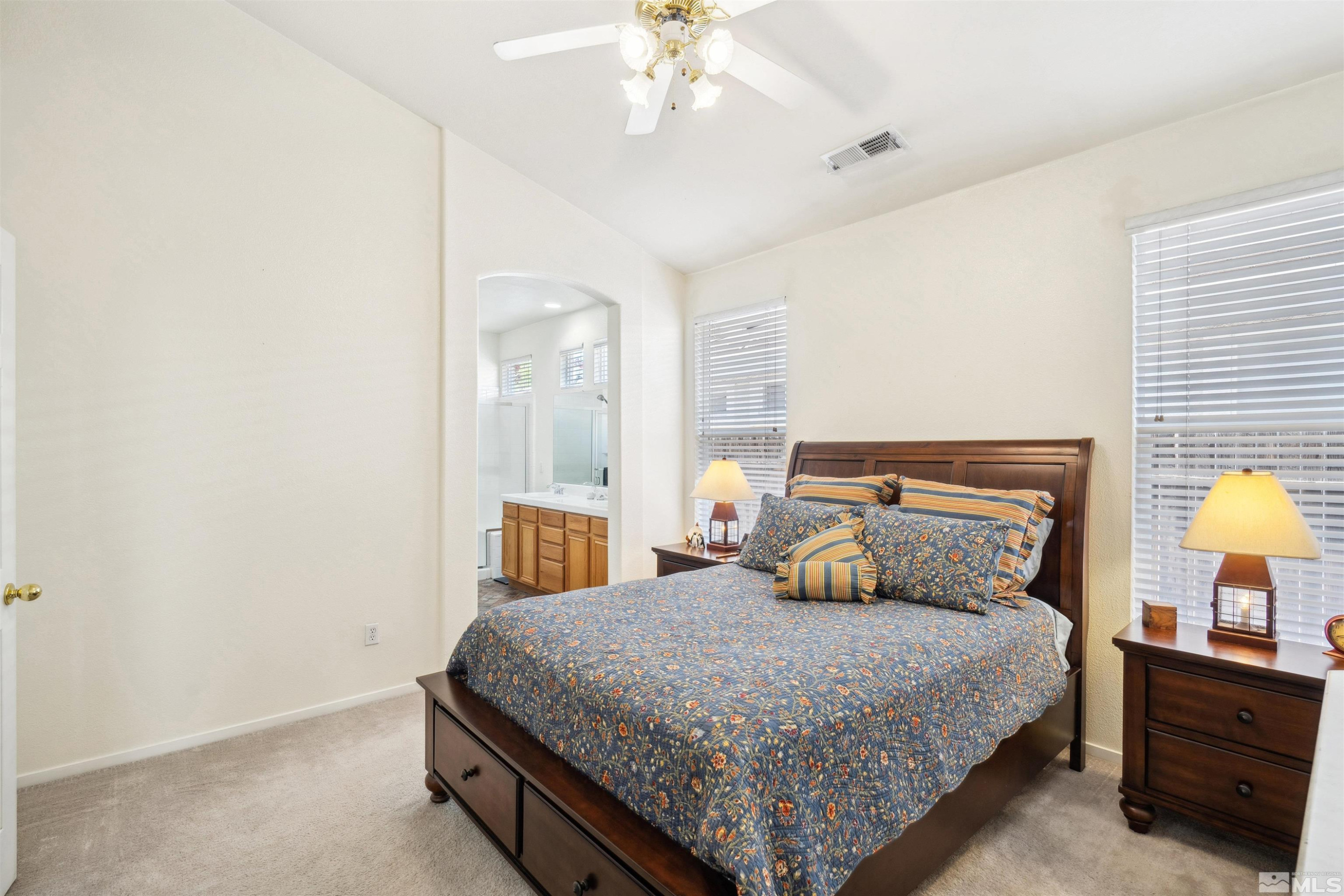 1236 Tule Drive Reno, NV 89521 - Photo 14 of 31 a bedroom with a bed and a chandelier