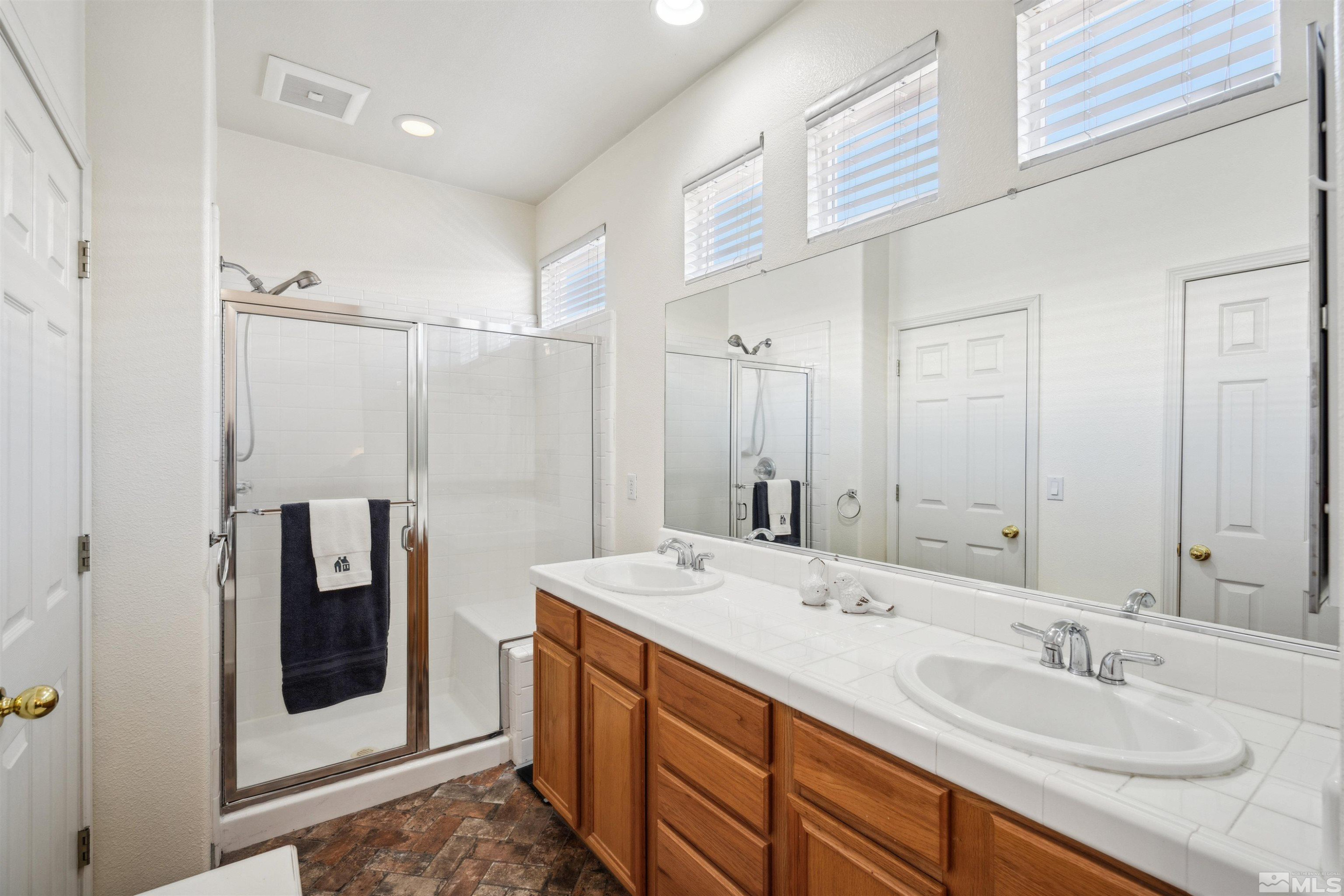 1236 Tule Drive Reno, NV 89521 - Photo 15 of 31 a bathroom with a double vanity sink and mirror