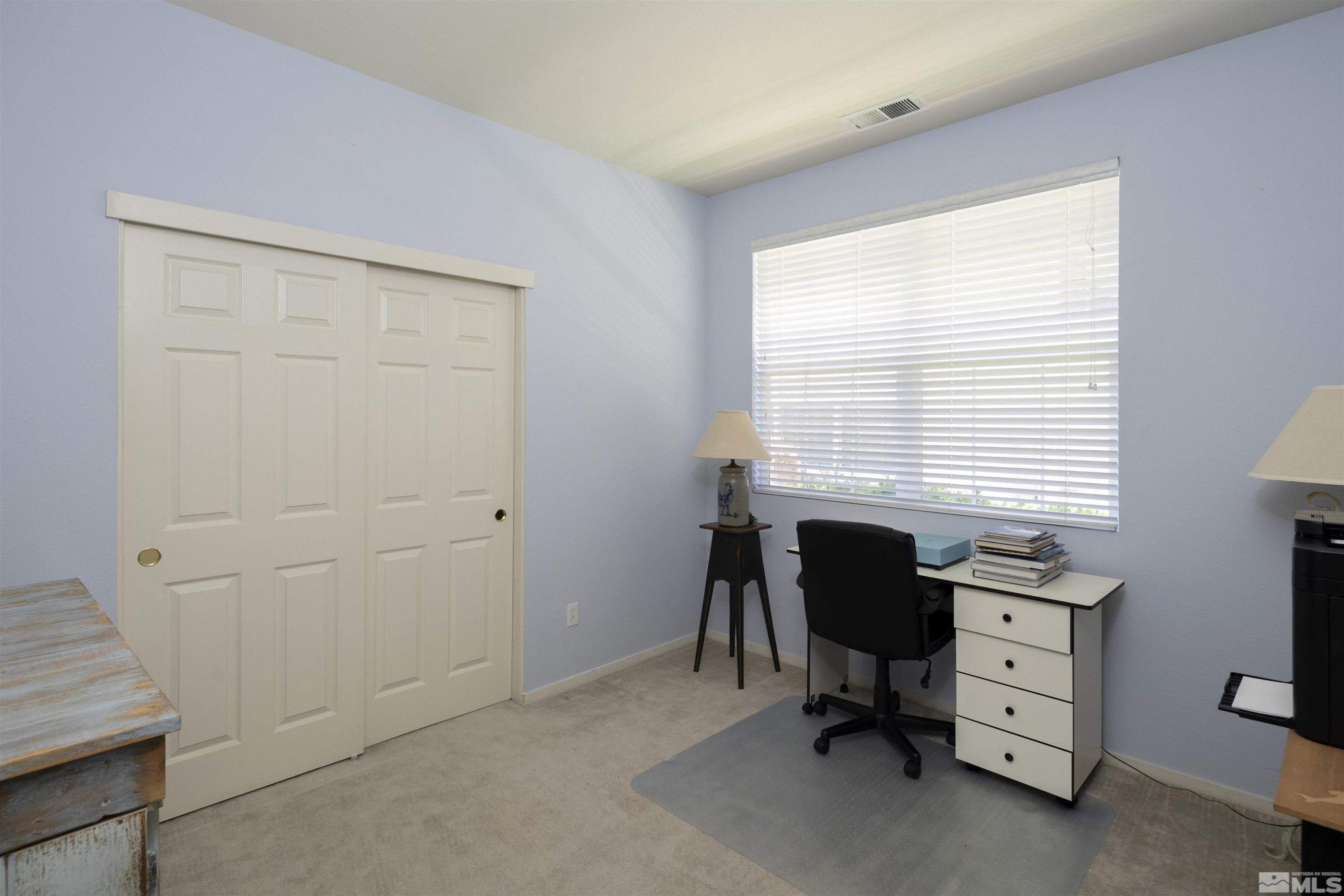 1236 Tule Drive Reno, NV 89521 - Photo 16 of 31 a view of a workspace with furniture and a window