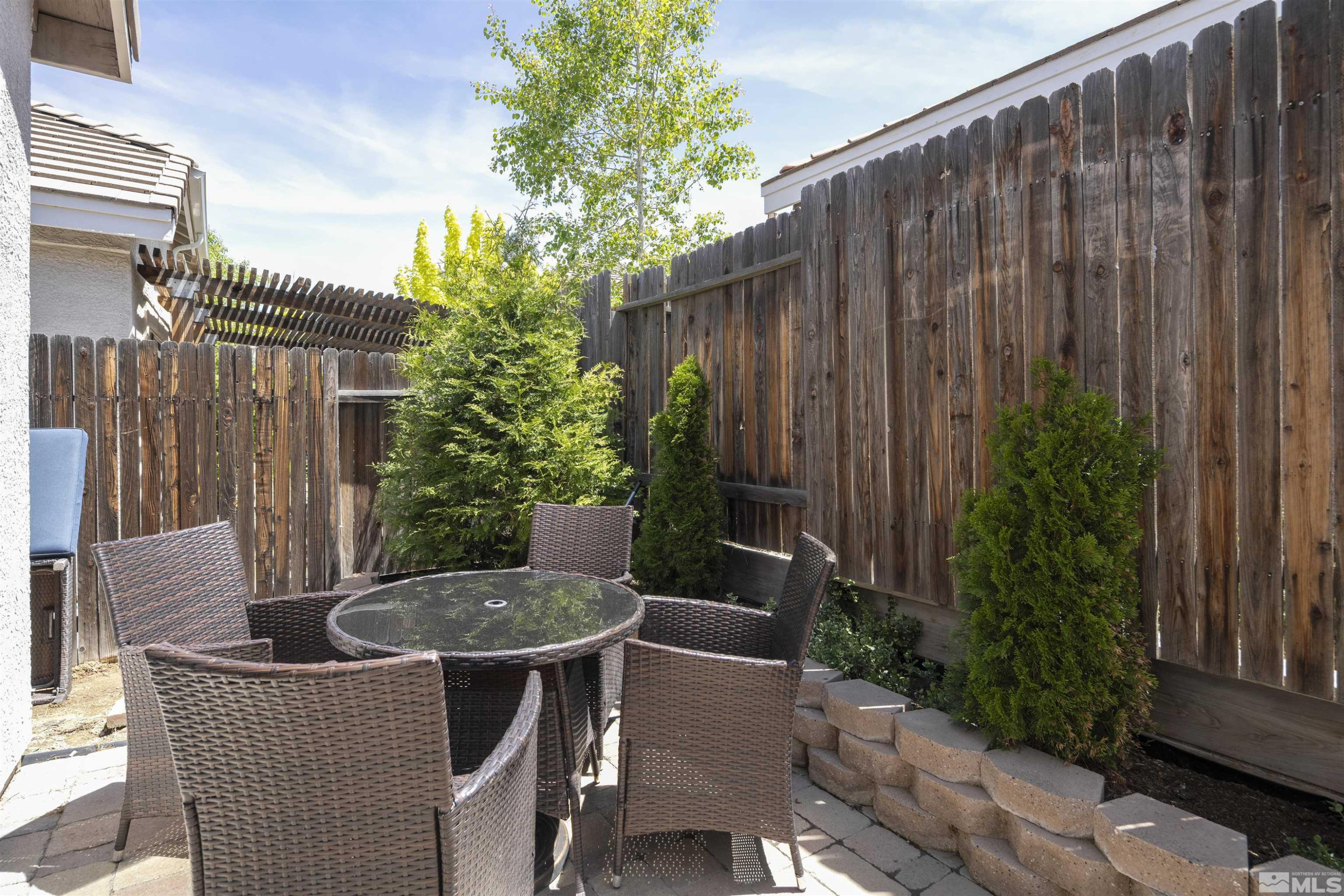 1236 Tule Drive Reno, NV 89521 - Photo 19 of 31 a view of outdoor sitting area with furniture and wooden fence