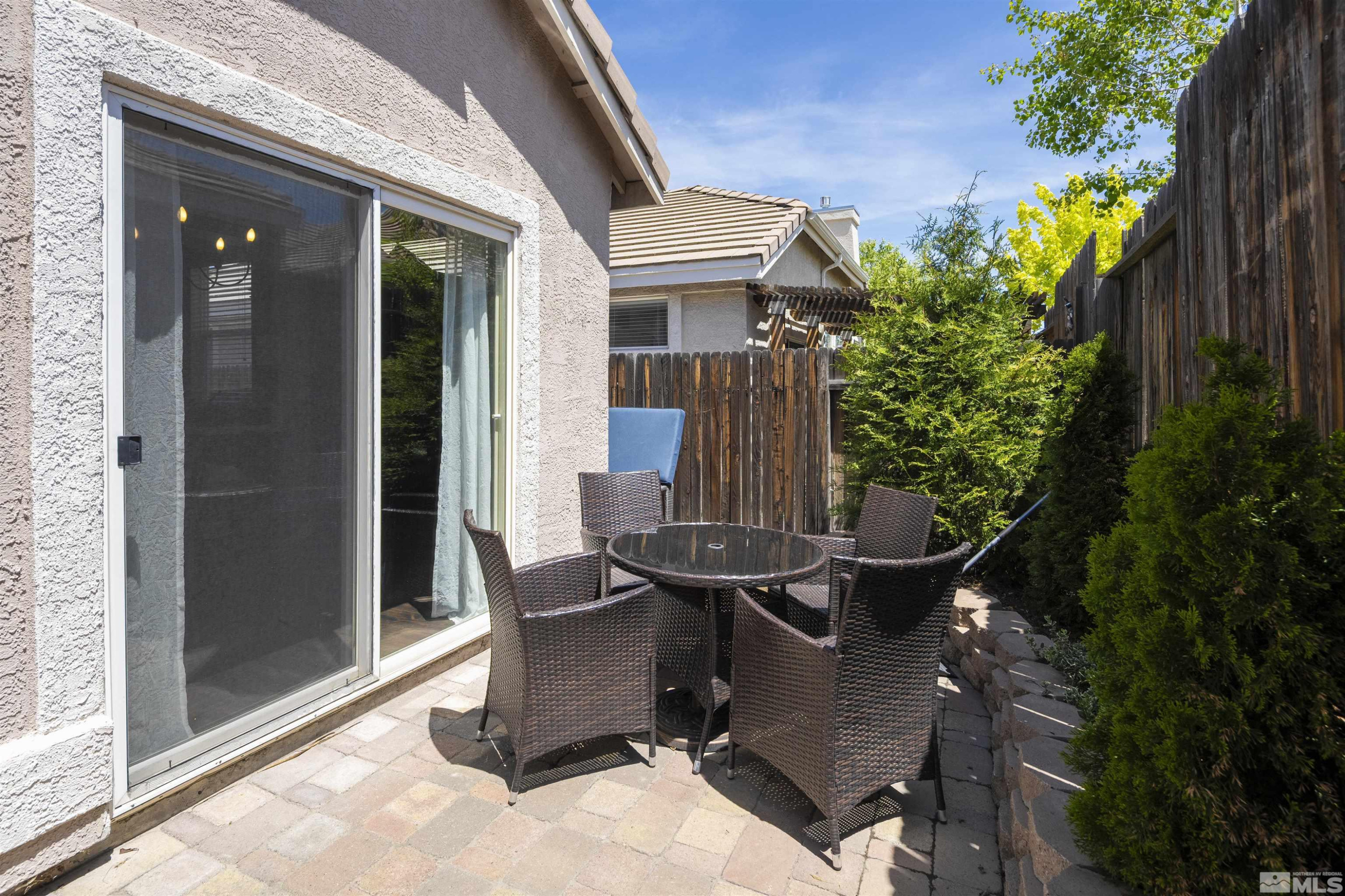 1236 Tule Drive Reno, NV 89521 - Photo 24 of 31 a view of backyard with a chair and potted plants