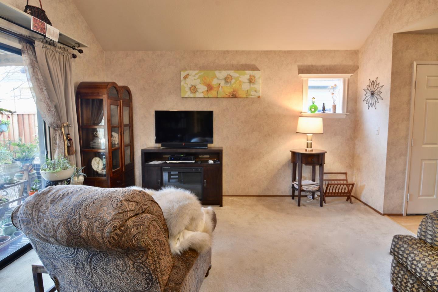 738 Natalie Drive Morgan Hill, CA 95037 - Photo 22 of 37 a bedroom with a bed tv and a window