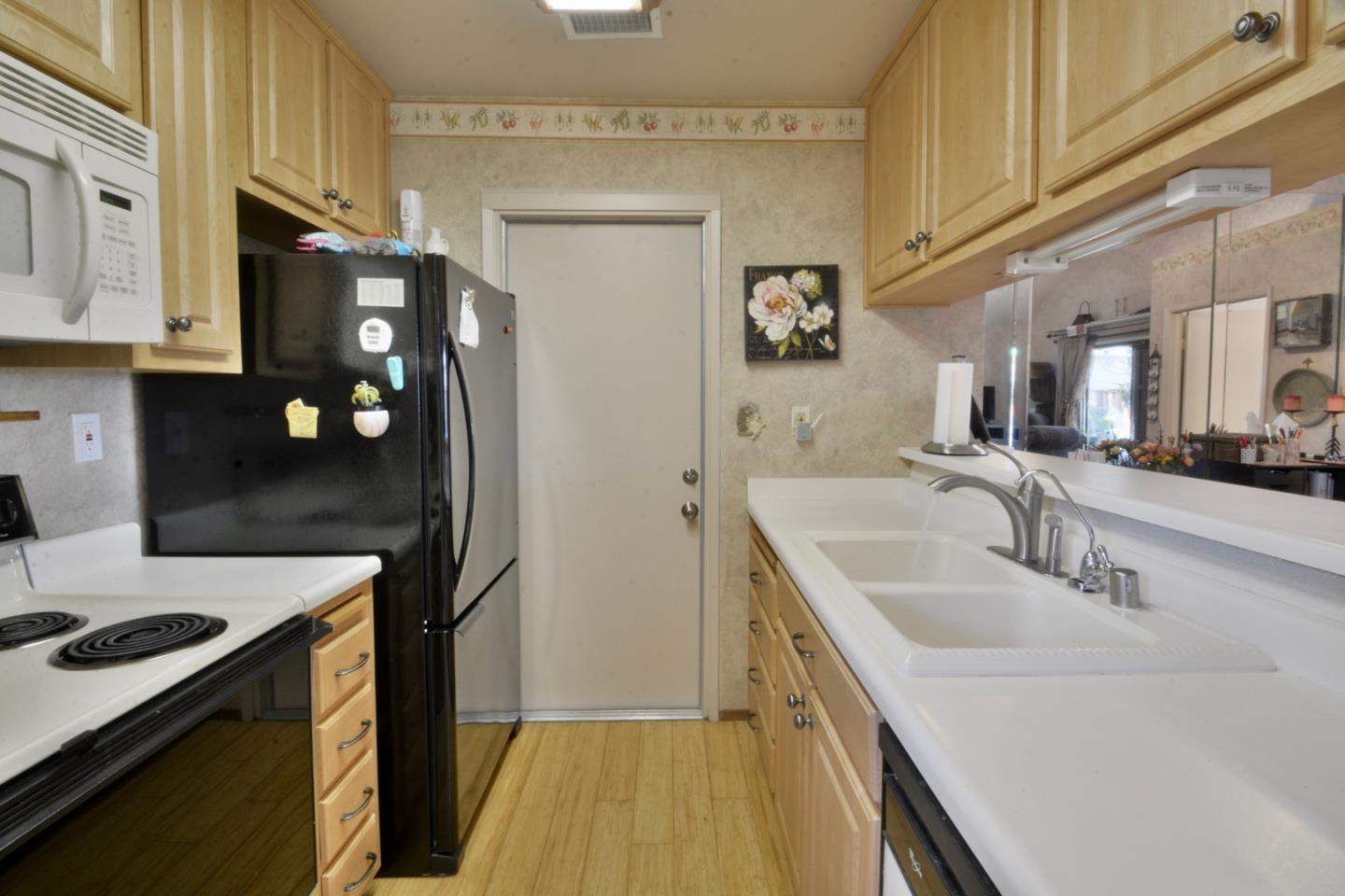 738 Natalie Drive Morgan Hill, CA 95037 - Photo 8 of 37 a kitchen with stainless steel appliances granite countertop a sink stove and refrigerator