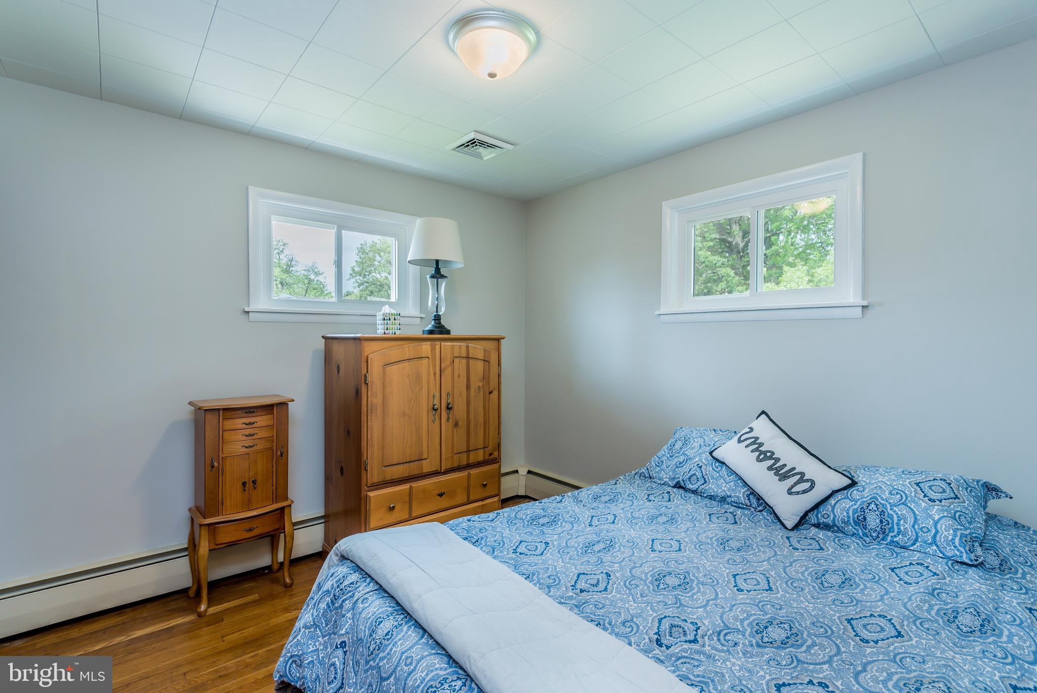 3518 Trindle Road, Unit 1 Camp Hill, PA 17011 - Photo 4 of 14 a bedroom with a bed and wooden floor