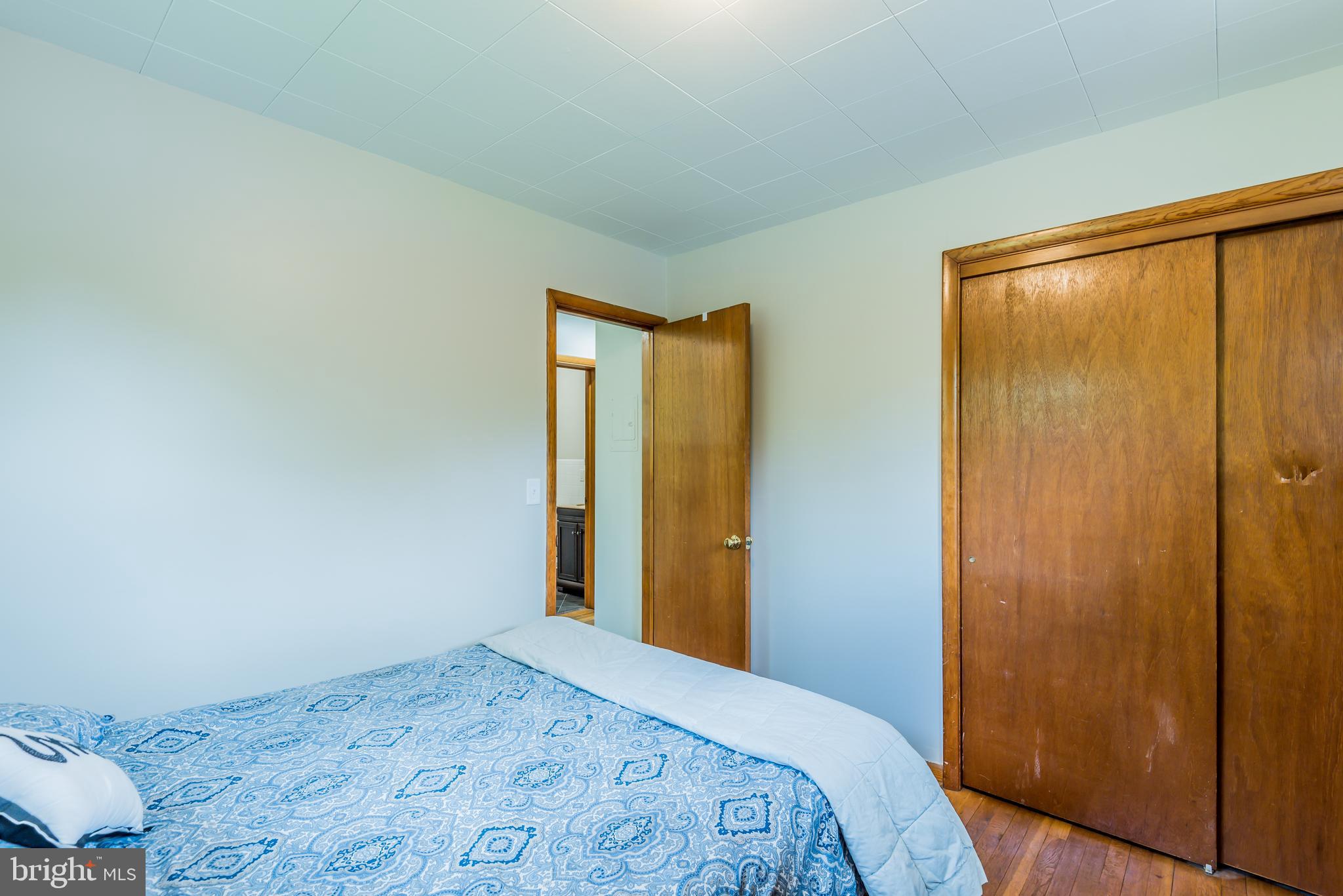 3518 Trindle Road, Unit 1 Camp Hill, PA 17011 - Photo 5 of 14 a bedroom with a bed and a dresser