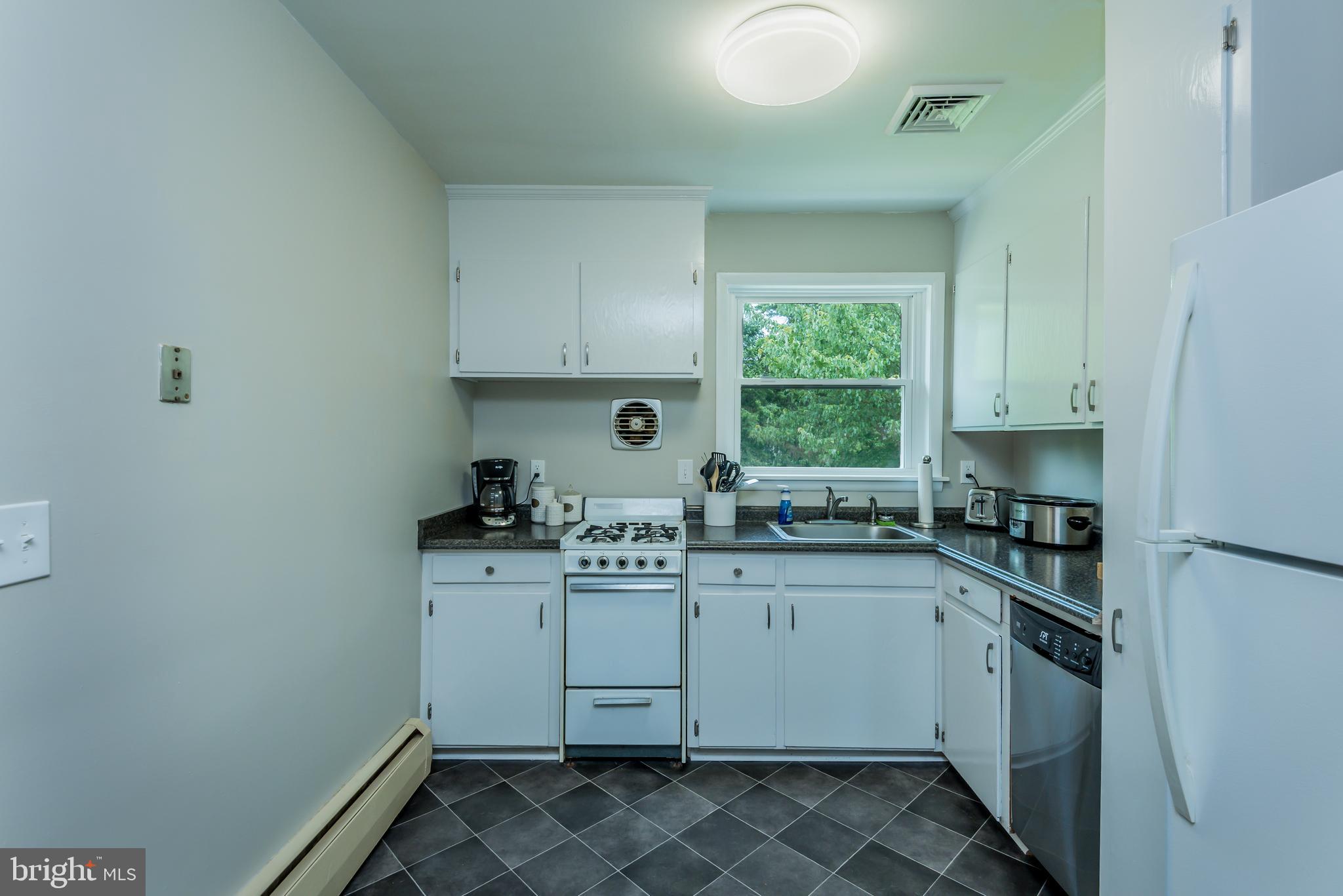 3518 Trindle Road, Unit 1 Camp Hill, PA 17011 - Photo 6 of 14 a kitchen with stainless steel appliances granite countertop a sink stove and refrigerator