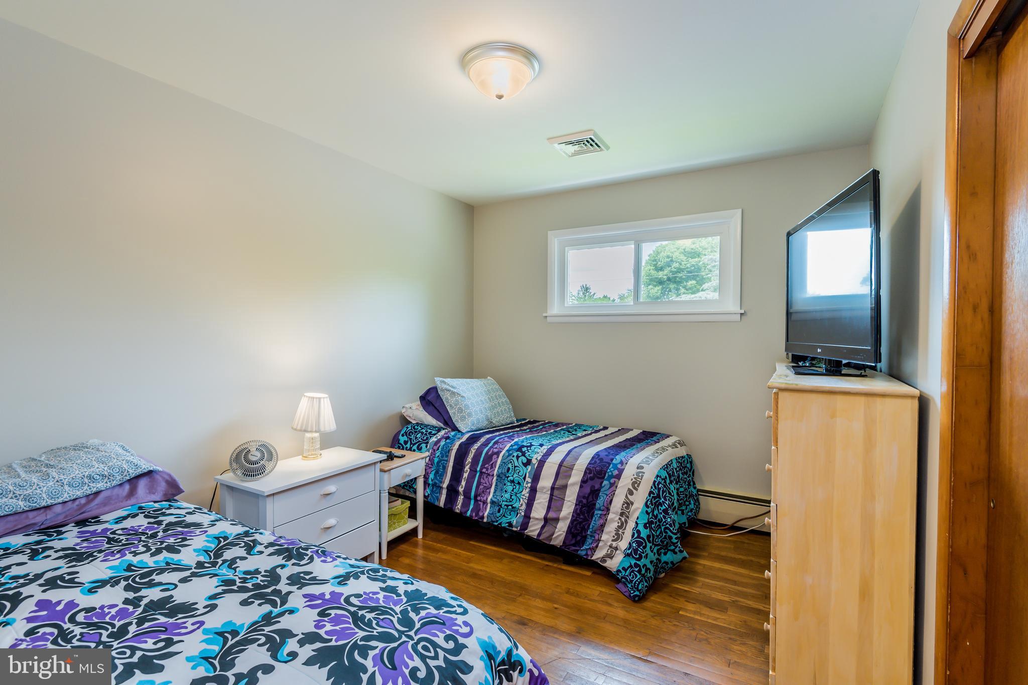 3518 Trindle Road, Unit 1 Camp Hill, PA 17011 - Photo 7 of 14 a bedroom with a bed and a lamp on dresser