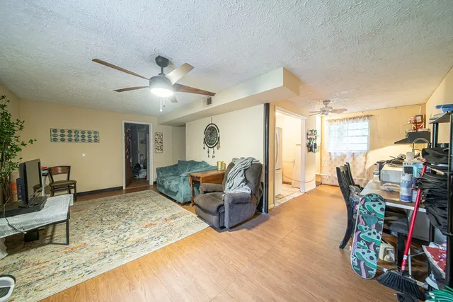 a living room with furniture and wooden floor